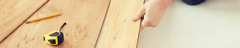 A professional installing wood flooring in New Haven, CT