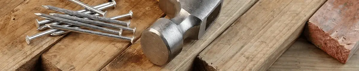 Hammer and nails on hardwood flooring boards in New Haven, CT