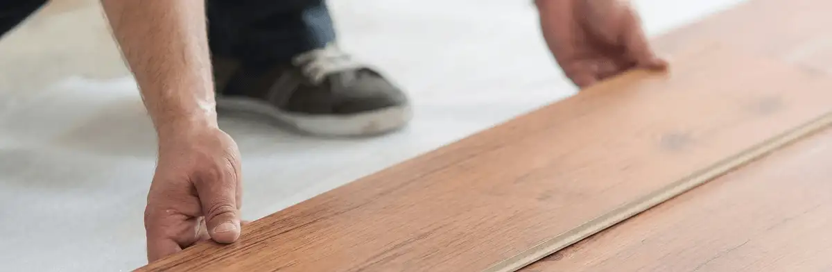 A professional installing laminate flooring in New Haven, CT